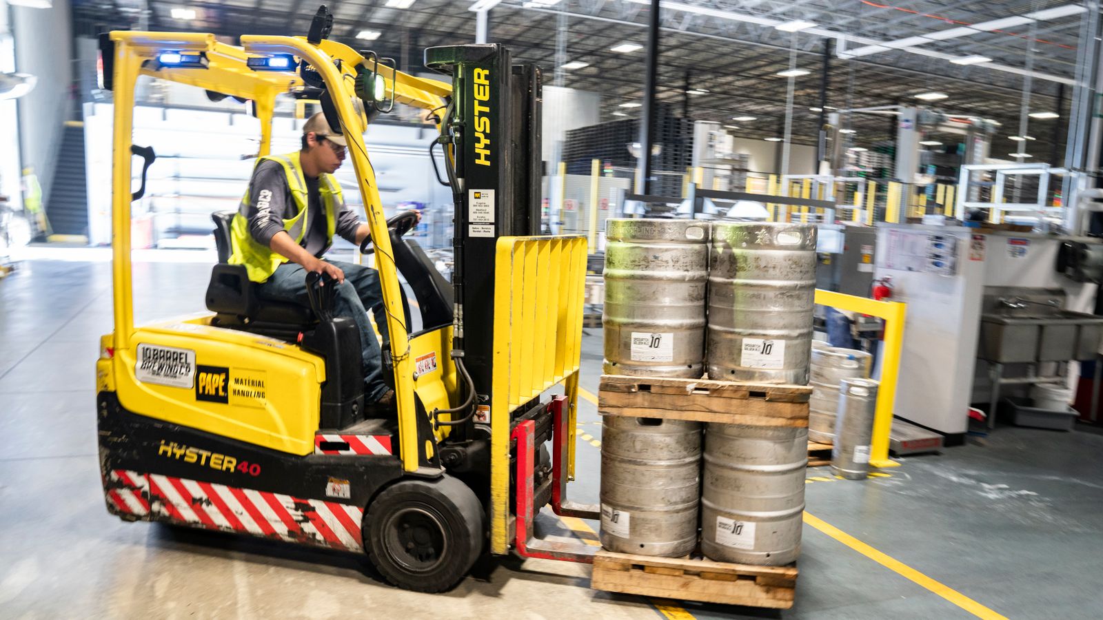 Kegs moved by forklift through a working keg plant