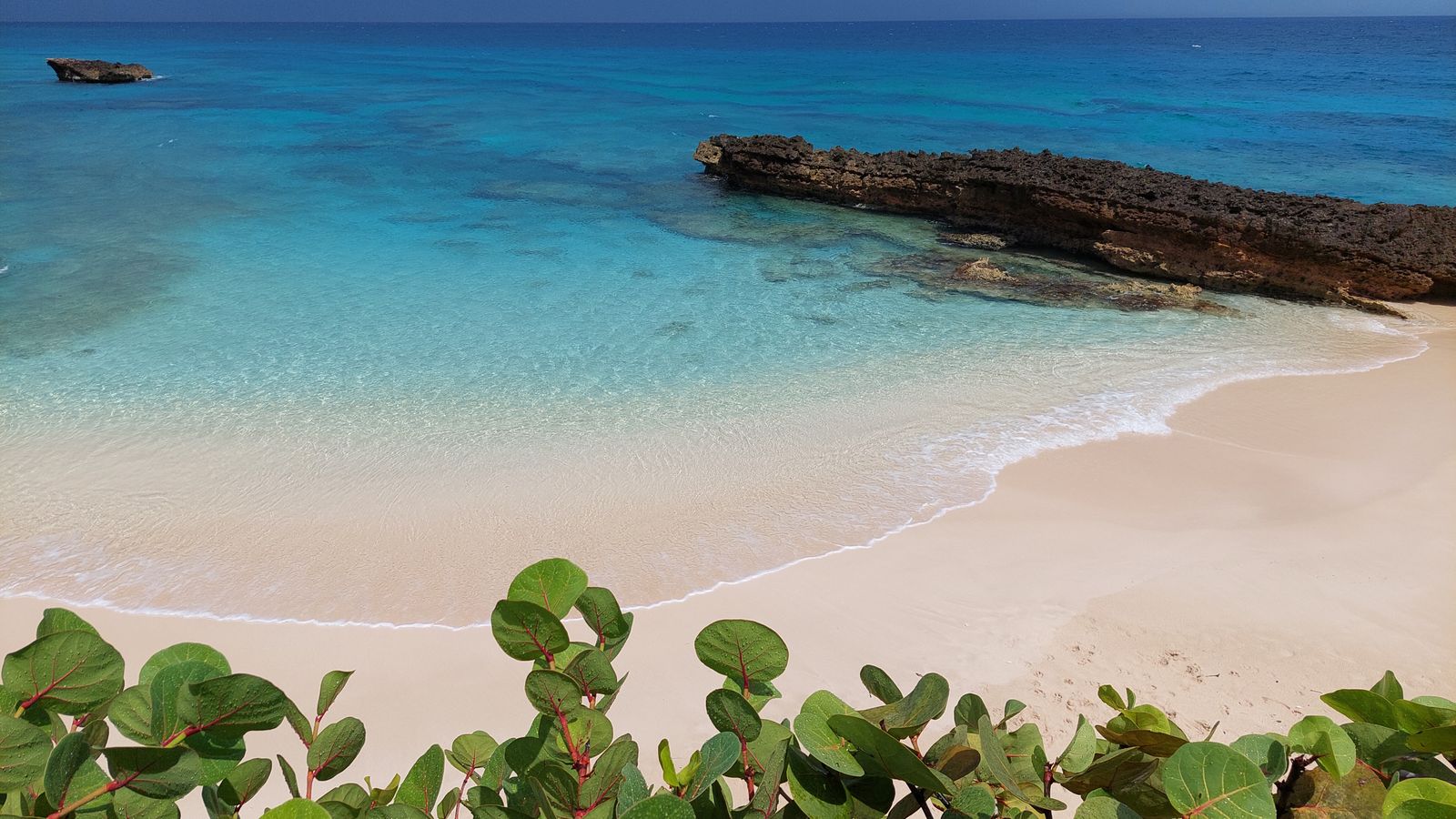 Calm turquoise shallows along a restored sand beach