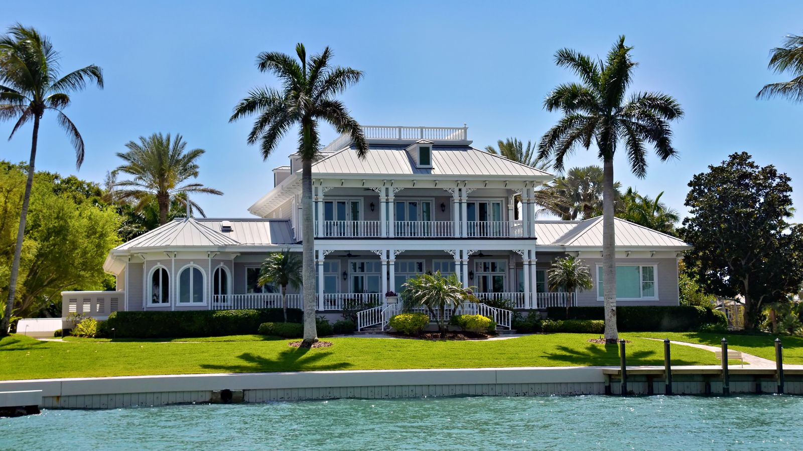 Waterfront villa among palm trees